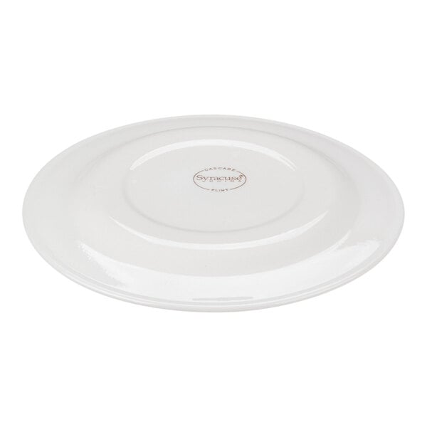 A white round porcelain plate shown upside down with a logo and text in the center.