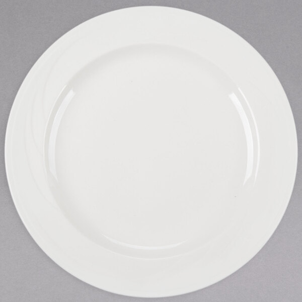 A Libbey ivory porcelain plate with a white rim on a gray background.