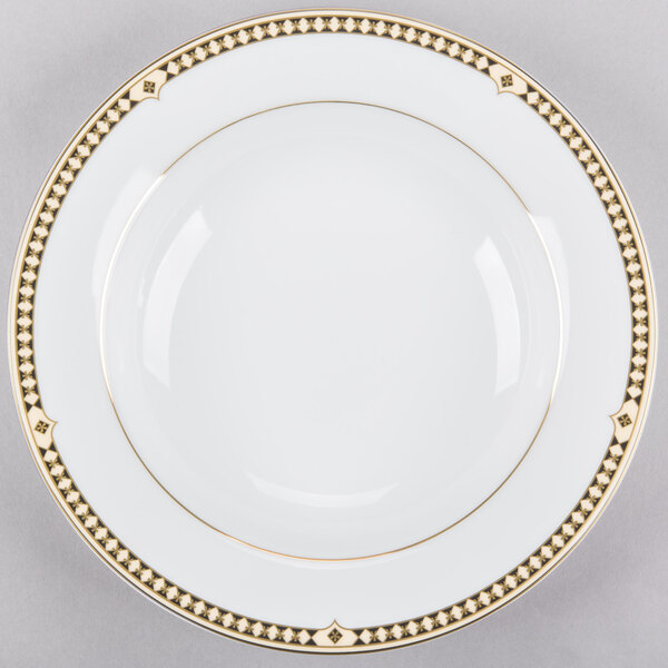A white Syracuse China bone china soup bowl with gold trim.