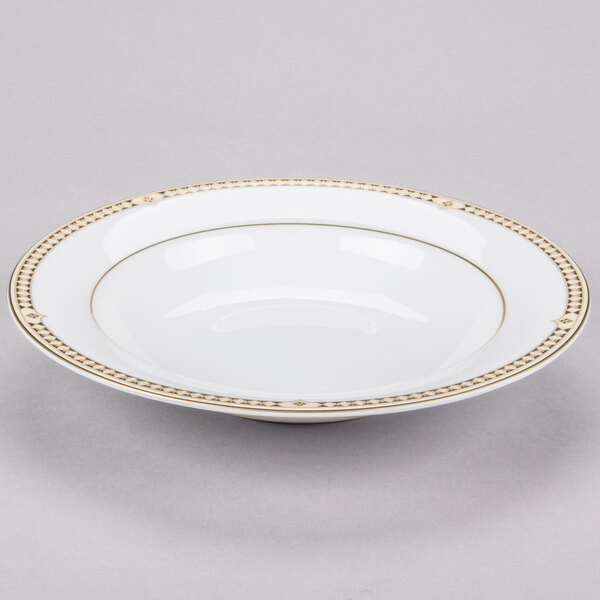A white Syracuse China bone china soup bowl with gold trim on the rim.