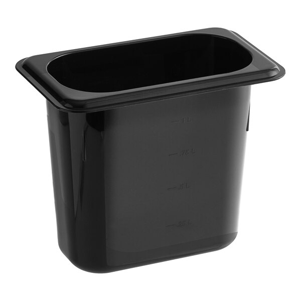 A Carlisle black polycarbonate food pan on a counter.