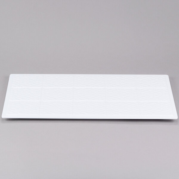 A white rectangular object with squares on it.