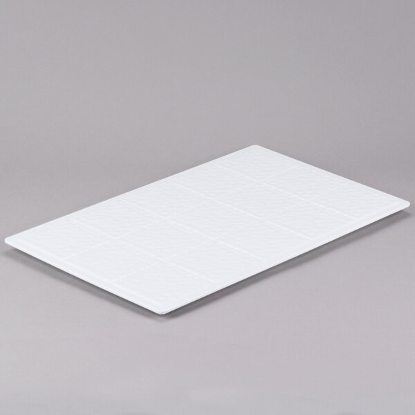 A white rectangular GET Melamine adapter plate with squares on it.