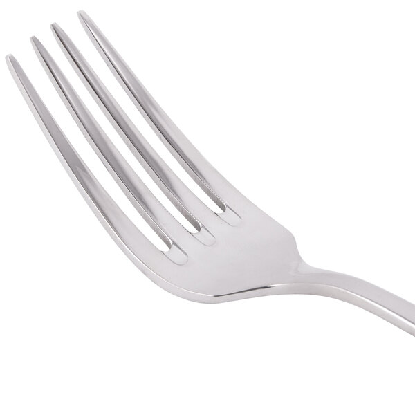 A Libbey stainless steel dessert fork with four tines.