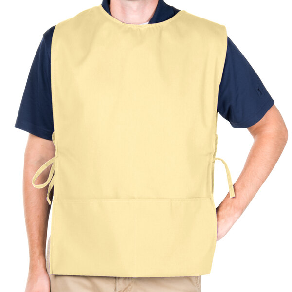 A man wearing a yellow Intedge cobbler apron.