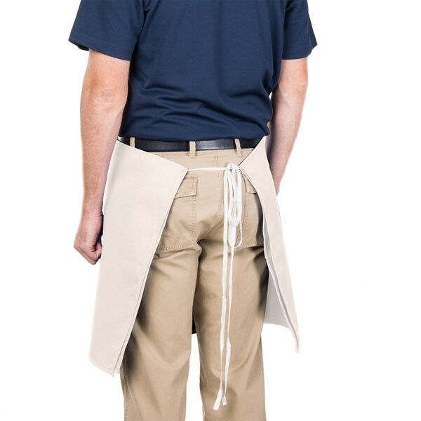 A man wearing an ivory Intedge waist apron.