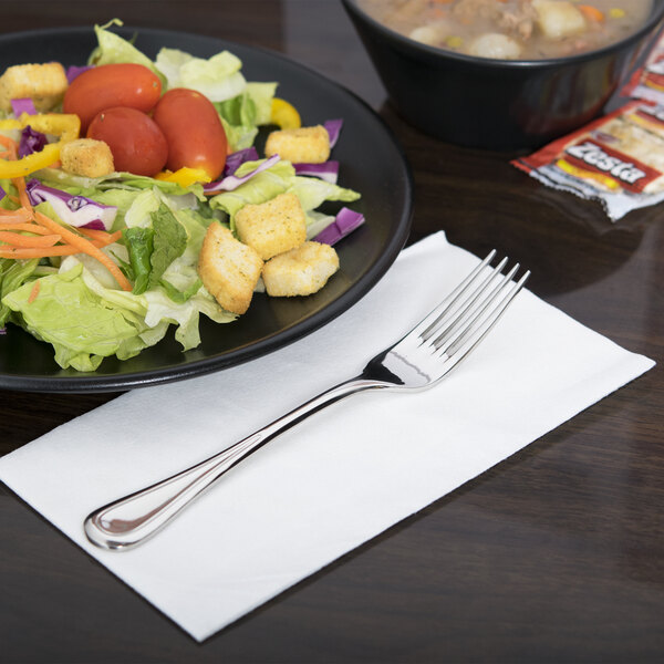 A plate of salad with a Libbey stainless steel dessert fork.