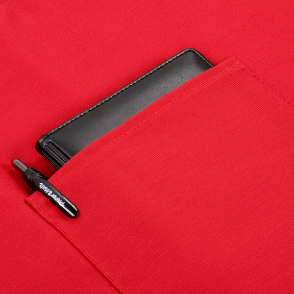 A red Intedge bistro apron pocket holding a wallet and pen.