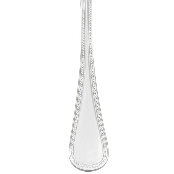 A stainless steel Libbey Calais demitasse spoon with a dotted handle.