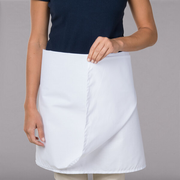 A woman wearing a white Intedge waist apron.