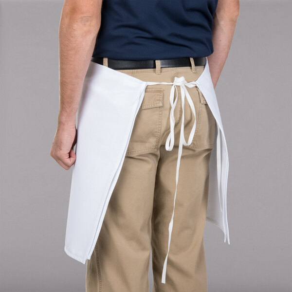 A man wearing a white Intedge waist apron.