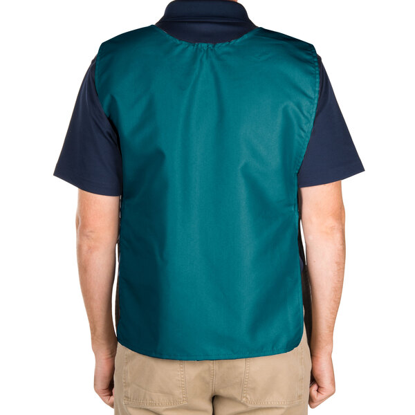 A man wearing an Intedge teal cobbler apron over a green vest.