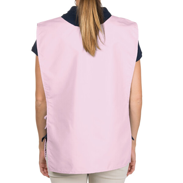 A woman wearing a pink Intedge cobbler apron.