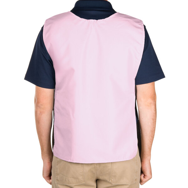 A man wearing a pink Intedge cobbler apron with two pockets.