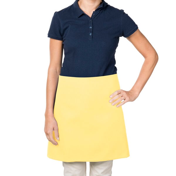 A woman wearing a yellow Intedge waist apron.