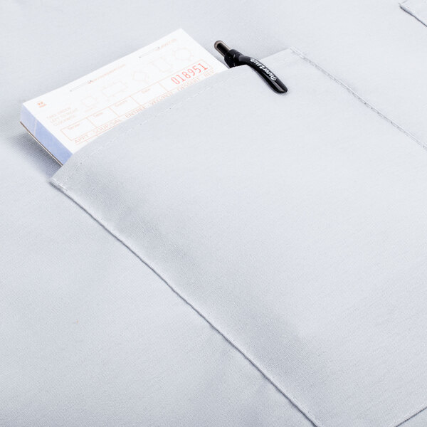 A pocket with a pen and a piece of paper in an Intedge gray bistro apron.