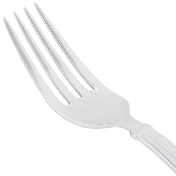 A close-up of a Libbey Aegean salad fork with a white handle.