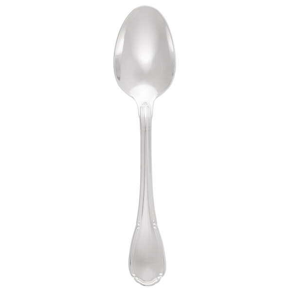 A silver spoon with a Baroque design on the handle.