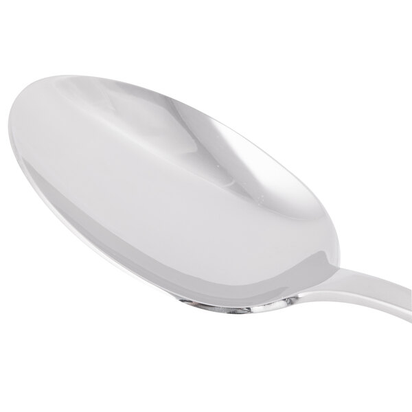 A Libbey stainless steel serving spoon with a white handle.