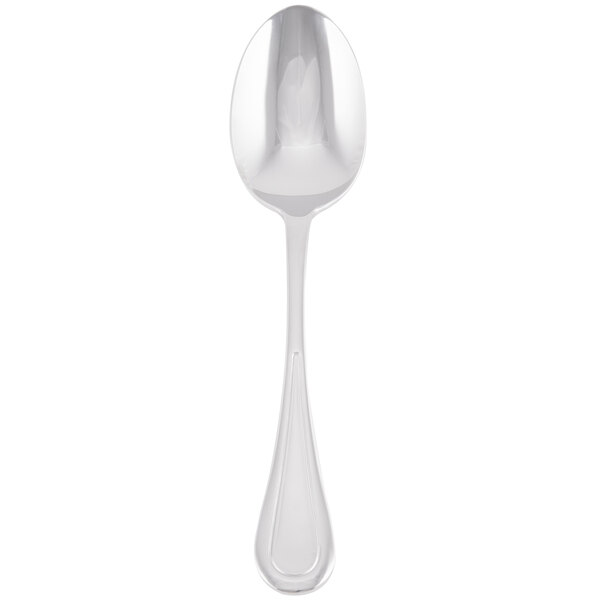 A silver Libbey serving spoon with a white handle.