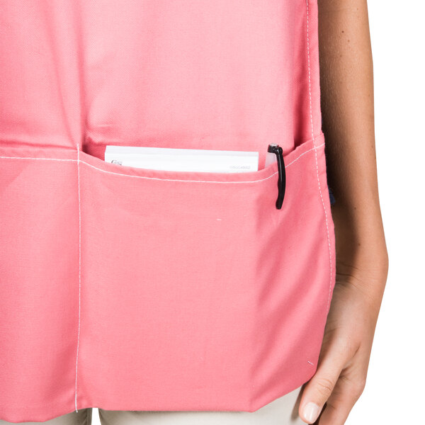 An Intedge mauve poly-cotton cobbler apron with pockets.