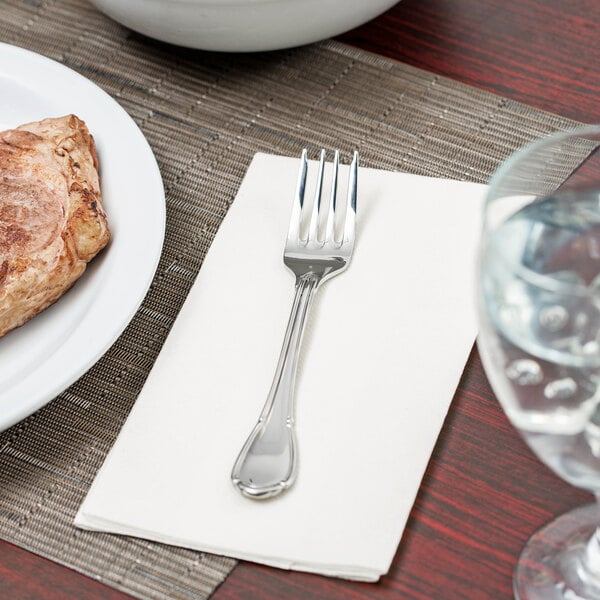 A close-up of a Libbey Baroque stainless steel salad fork.