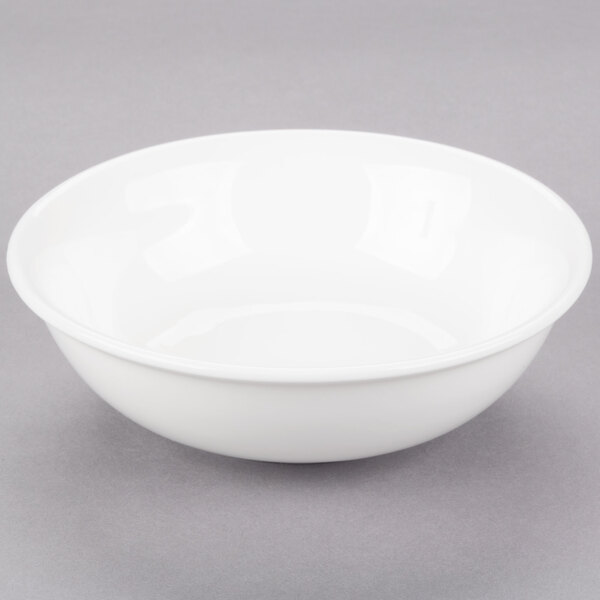 A 10 Strawberry Street Bistro bright white porcelain fruit bowl on a gray surface.
