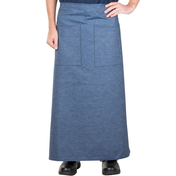 A man wearing a blue denim Intedge bistro apron.