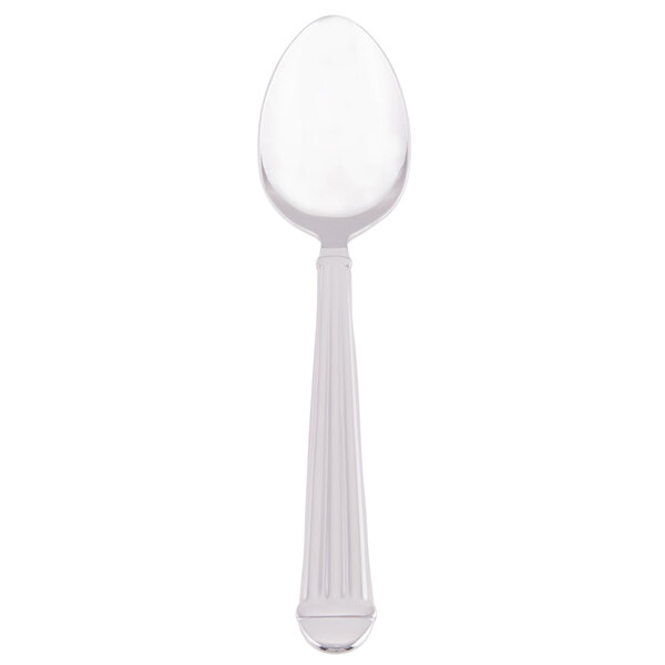 A Libbey stainless steel dessert spoon with a white handle.