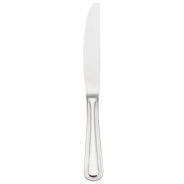 A Libbey stainless steel dinner knife with a solid handle and serrated blade.