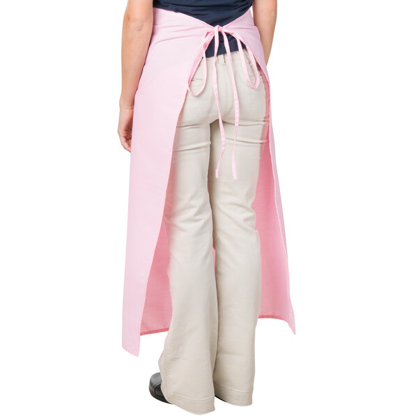 A woman wearing a pink Intedge bistro apron.