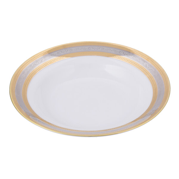A white porcelain soup bowl with a gold rim.