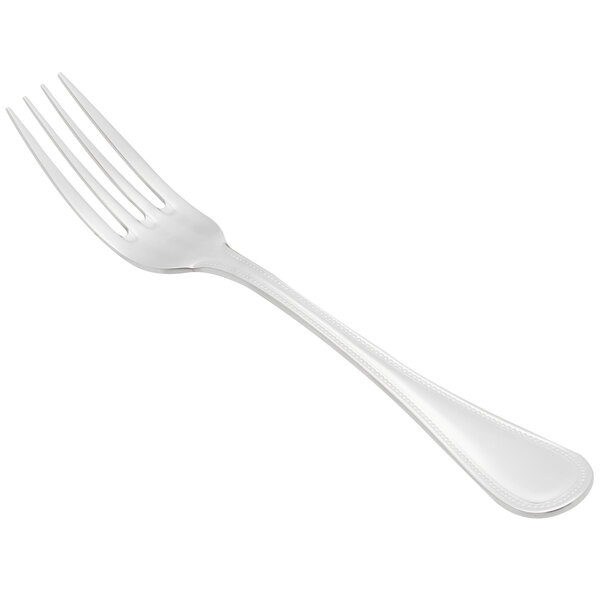 A silver Libbey stainless steel European dinner fork with a white handle.