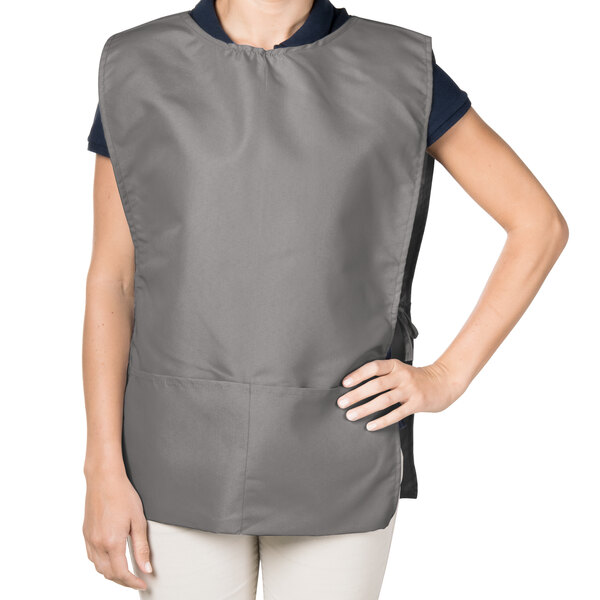 A woman wearing a gray Intedge cobbler apron.