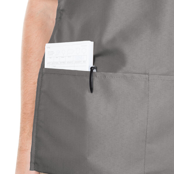 A man wearing a grey Intedge cobbler apron with pockets.