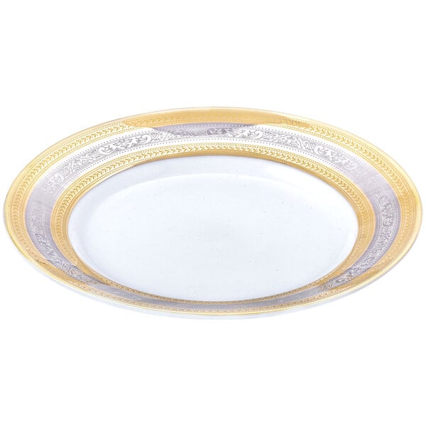 A close-up of a 10 Strawberry Street Elegance porcelain bread and butter plate with a white center, gold rim, and gold accents.