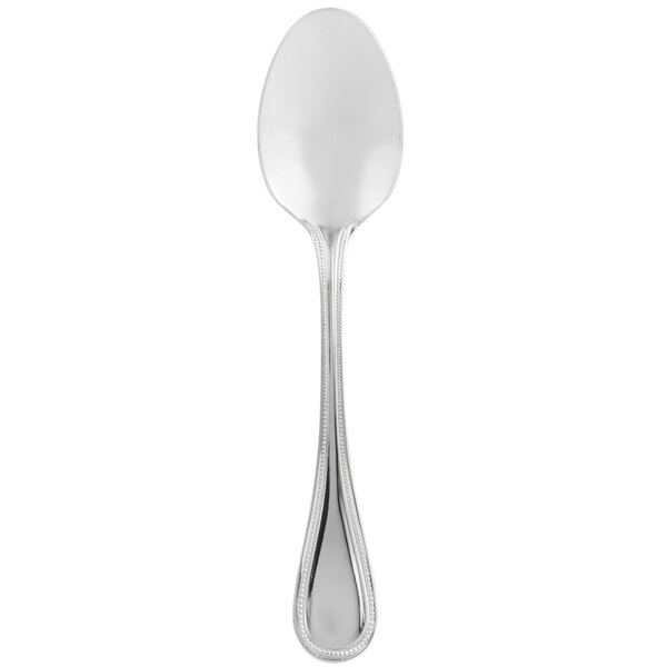A close up of a Libbey stainless steel teaspoon with a white background.