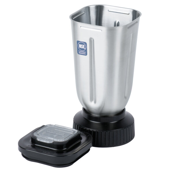 A close-up of a silver Waring blender jar with a lid.