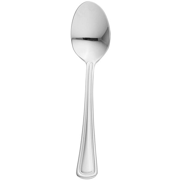 A close-up of a Libbey stainless steel teaspoon with a white handle.