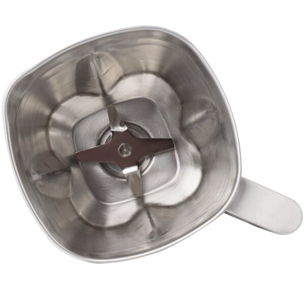A stainless steel Waring blender jar with a metal blade.