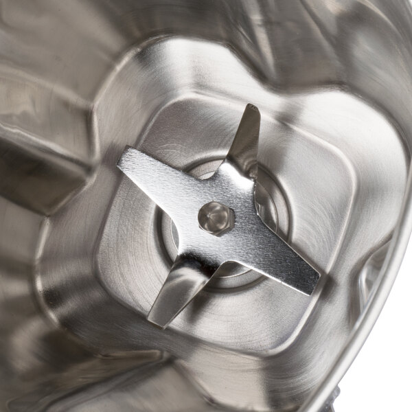 A Waring stainless steel blender jar with a metal blade.