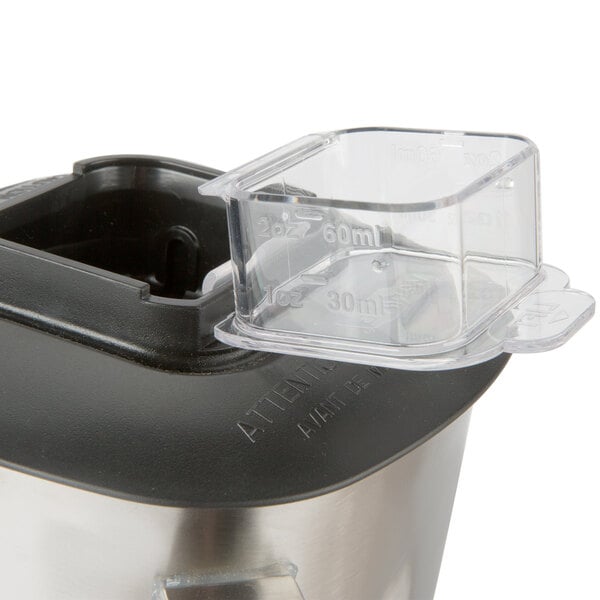 A Waring stainless steel blender jar on a blender.