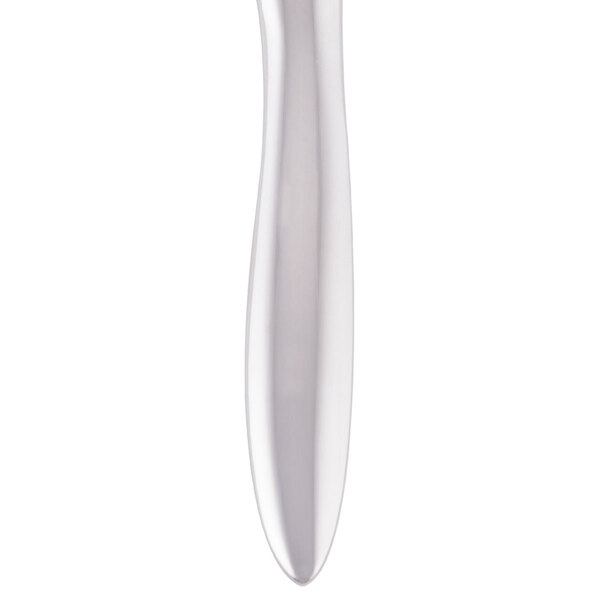 A silver steak knife with a white handle.