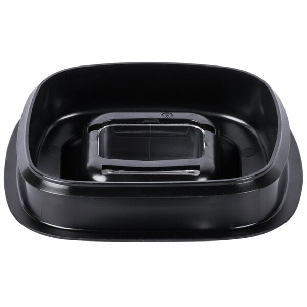 A black plastic jar lid with a clear measuring cup inside.