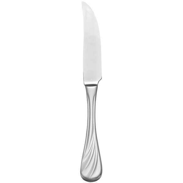 A silver steak knife with a white handle.