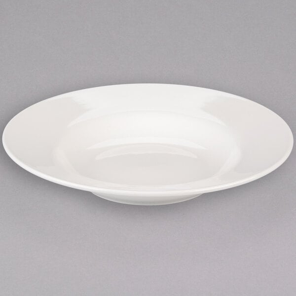 A Libbey ivory porcelain pasta bowl with a wide rim on a white background.