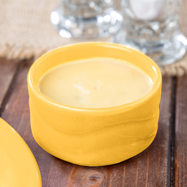 A yellow Libbey Cantina bowl filled with food.