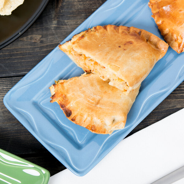 A piece of food on a Libbey blueberry carved rectangular porcelain tray.