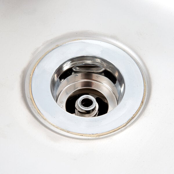 A close-up of a stainless steel sink drain.