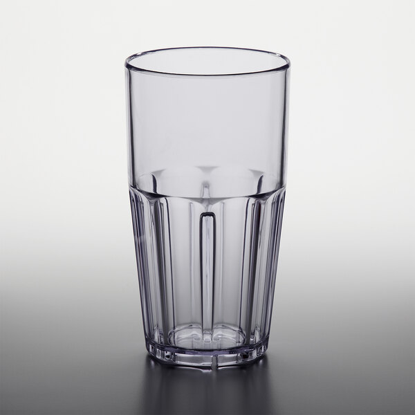 A clear plastic tumbler with a black rim.
